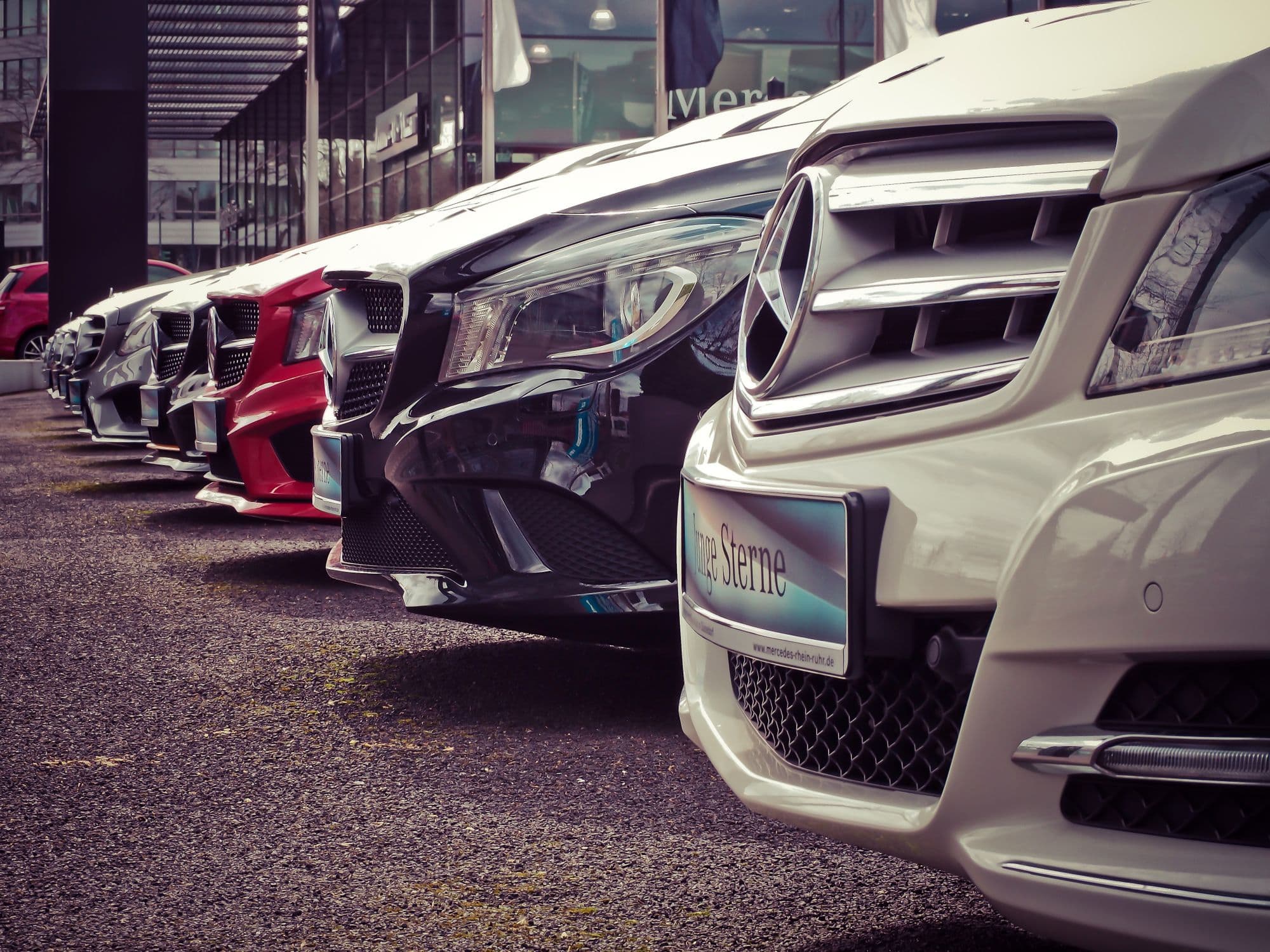 Row of vehicles lined up at a dealership